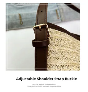 Detail of adjustable leather strap with golden metal buckle on woven bucket bag