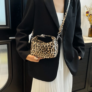 Vintage leopard print crossbody bag with silver buckle and adjustable shoulder strap