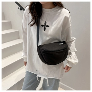 Detail of black canvas half-moon crossbody bag with adjustable strap and fashion label