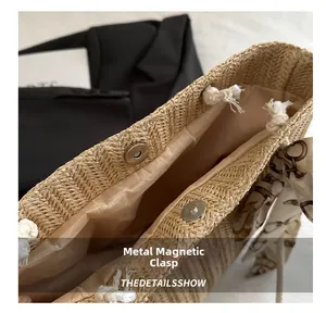 Detailed close-up of straw tote bag showing magnetic metal closure and soft fabric lining