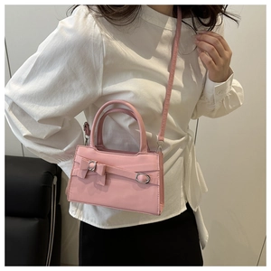 Détail du sac à bandoulière rose à nœud papillon avec boucle en métal argenté