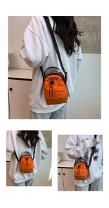 Detail of waterproof nylon crossbody phone bag in orange and brown with drawstring