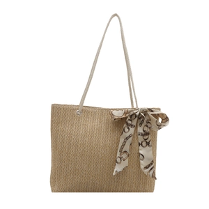 Women's woven straw tote bag with elegant patterned scarf and slim shoulder straps
