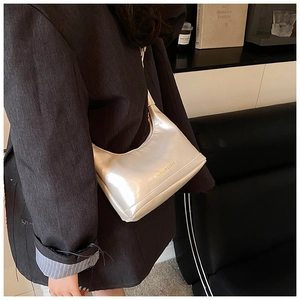 Detail of silver metallic hobo bag with Fashion & Bags text shown on a model