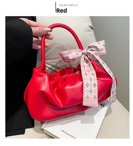 Dettaglio borsa a nuvola rossa increspata con elegante foulard di seta a scacchi
