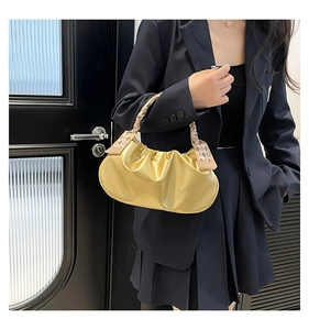 Champagne gold ruched cloud bag featuring a woven handle and checkered scarf detail