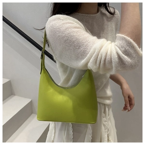 Detail of lime green leather hobo bag with adjustable strap and silver metal buckle