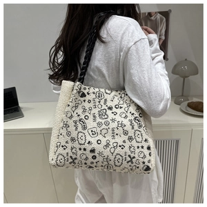 Detail of hand-drawn cartoon graffiti on large capacity woven tote bag with black straps