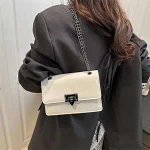 White patent leather shoulder bag with a V-shaped metal buckle and chain strap