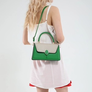 Minimalist green and beige woven crossbody bag with metal buckle shown on a model