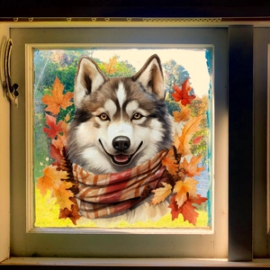 Close-up of husky window sticker with autumn maple leaves on white wooden window frame