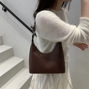 Minimalist brown hobo shoulder bag in faux leather with adjustable strap for women