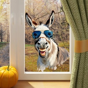 Close-up of a funny donkey window sticker with blue aviator sunglasses on glass background