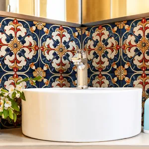 Close-up of retro geometric tile stickers on a bathroom wall behind a white ceramic basin