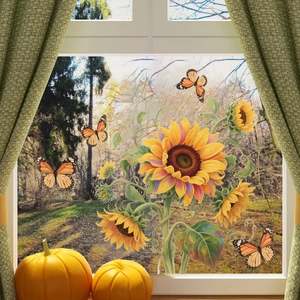 Vibrant sunflower and butterfly window stickers on a glass frame with autumn pumpkin decor