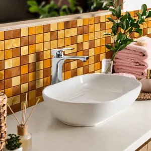 Close-up of waterproof adhesive mosaic tile stickers with orange and yellow checkered pattern