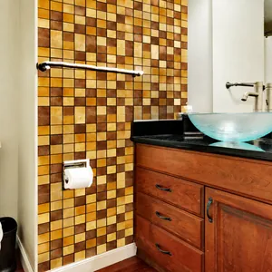Close-up of vintage brown and yellow mosaic tile wall stickers in a bathroom setting