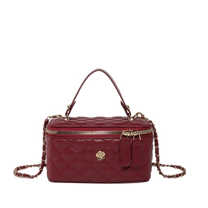 Elegant burgundy quilted vanity bag with gold floral clasp and chain strap on white background