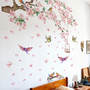 Floral wall stickers detail featuring watercolor pink cherry blossoms and colorful birds