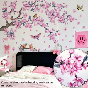 Detail of pink cherry blossom wall stickers with birds on a bedroom background