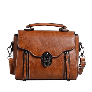 Retro caramel brown leather handbag with top handle and adjustable shoulder strap for women