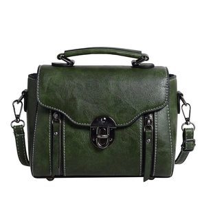 Dark green vintage leather handbag with white stitching and metal buckle on white background