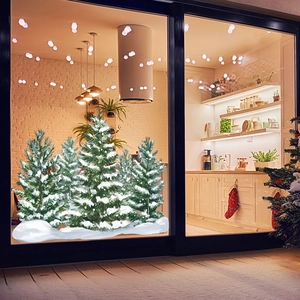 Detail of pine tree window stickers with thick white snow on a glass surface