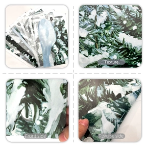 Detail of snowy pine tree window stickers showing texture and adhesive backing side