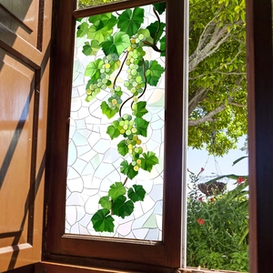 Green vine window static cling film featuring grapes and leaves on a wooden window