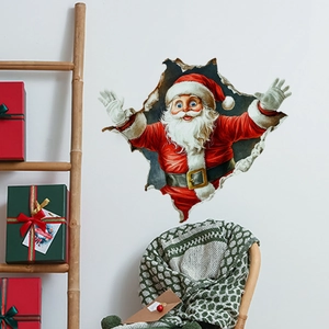 3D Christmas Santa Claus wall decal shown in a cozy living room with festive gift boxes