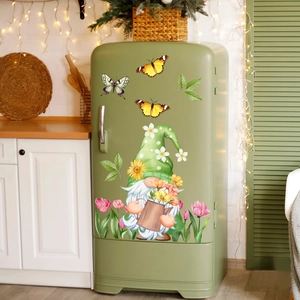 Close-up of a spring garden gnome sticker set with flowers and butterflies on a green fridge
