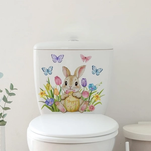 Detail of bunny holding a Happy Easter egg wall sticker on a white surface