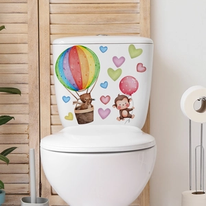 Close-up of watercolor hot air balloon and cartoon animals on a toilet tank sticker