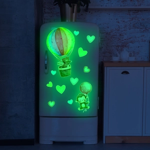 Glow-in-the-dark wall stickers featuring monkeys in hot air balloons and green hearts