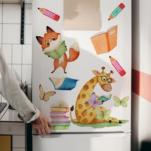 Detailed view of fox and giraffe cartoon wall stickers on a white refrigerator