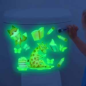 Glow-in-the-dark wall stickers featuring a giraffe and fox with bright green luminescence