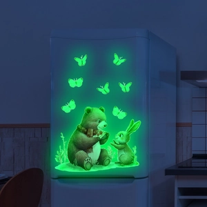 Luminous wall stickers featuring glowing cartoon bear and rabbit on a white fridge