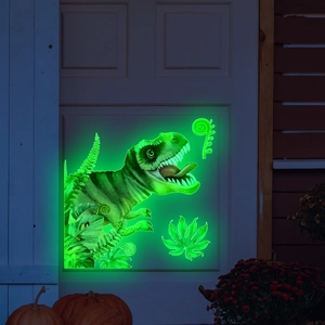 Luminous green T-Rex dinosaur and tropical leaves wall stickers glowing on white door