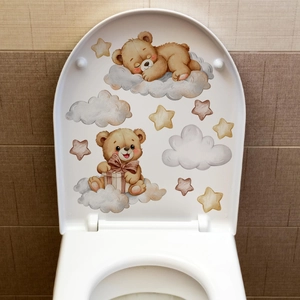 Close-up of cute cartoon bears, clouds and stars stickers applied on a white toilet lid