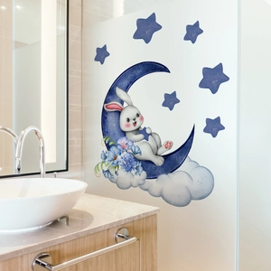 Detail of blue cartoon rabbit on moon wall sticker applied to bathroom glass partition