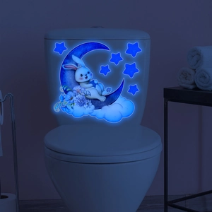 Glow-in-the-dark wall sticker featuring a cute bunny on a moon with stars in a bathroom