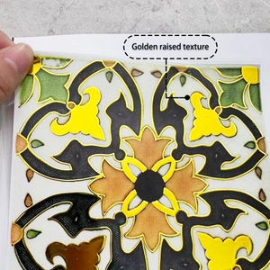 Close-up of golden raised texture tile sticker with vintage floral pattern and embossed finish