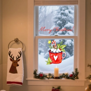 Close-up of red Christmas mug window sticker and Merry Christmas festive lettering decoration