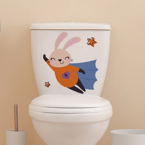 Luminous cartoon rabbit wall sticker with blue cape and orange stars on toilet tank