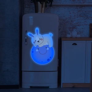 Luminous bunny on a blue moon wall sticker glowing in a dark kitchen setting