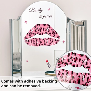 Detail of pink leopard lips wall sticker with Beauty is power text on vanity mirror