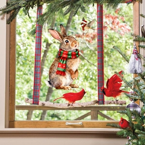 Detailed Christmas window stickers featuring watercolor rabbits and cardinals on a window