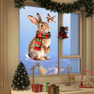 Close-up of Christmas window stickers featuring a bunny with scarf and bird on glass