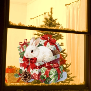 Detail of Christmas window sticker showing a white rabbit in a gift box on glass