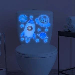 Glow-in-the-dark space decals featuring rockets and astronauts for bathroom wall decor